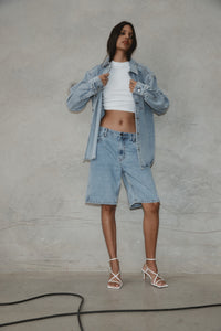 vegan leather heels, white, the stella multistrap strappy heel,worn with denim shorts against a stone backdrop,by edie collective
