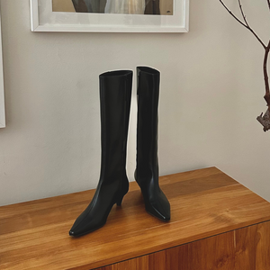 Knee high boot, luxury vegan leather knee high boot, on a wooden surface white backdrop